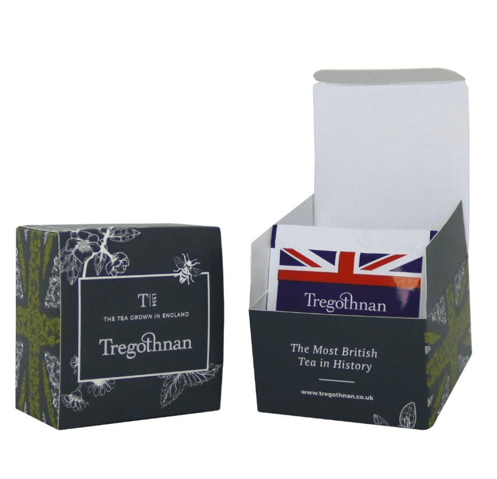 2 Elegant Tregothnan tea box with botanical and bee design, one with the lid open showing a tea bag inside.