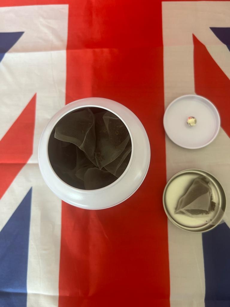 image from above of the Majestea tea caddy showing the pyramid bags inside on a union jack flag